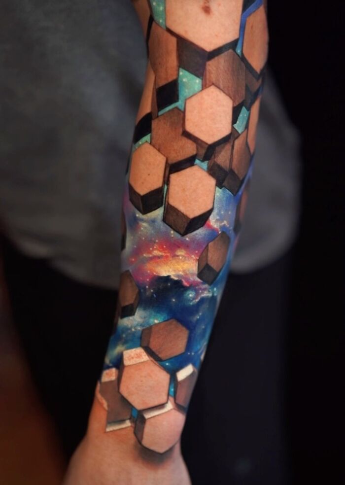 3D tattoo on forearm by Jesse Rix featuring hexagonal shapes and a cosmic portal to another world design.