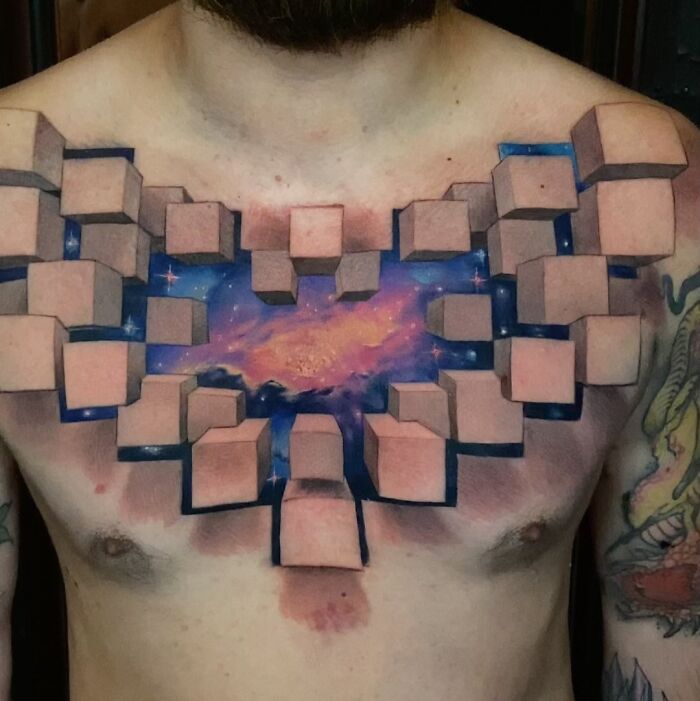 3D tattoo on chest by Jesse Rix featuring cubes revealing a cosmic portal to another world with stars and galaxies.
