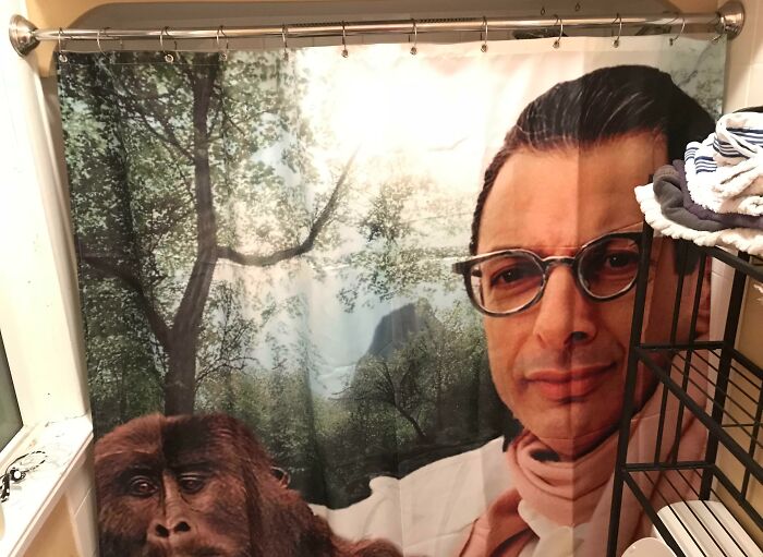 Shower curtain with a printed image of a man with glasses and a gorilla, showing clueless partner humor in a bathroom setting.