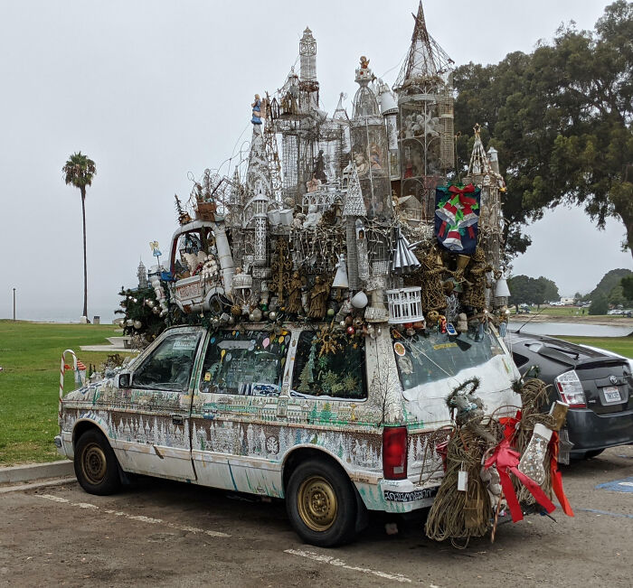 Outrageous car mods featuring an extensively decorated van with elaborate rooftop sculptures and holiday ornaments.
