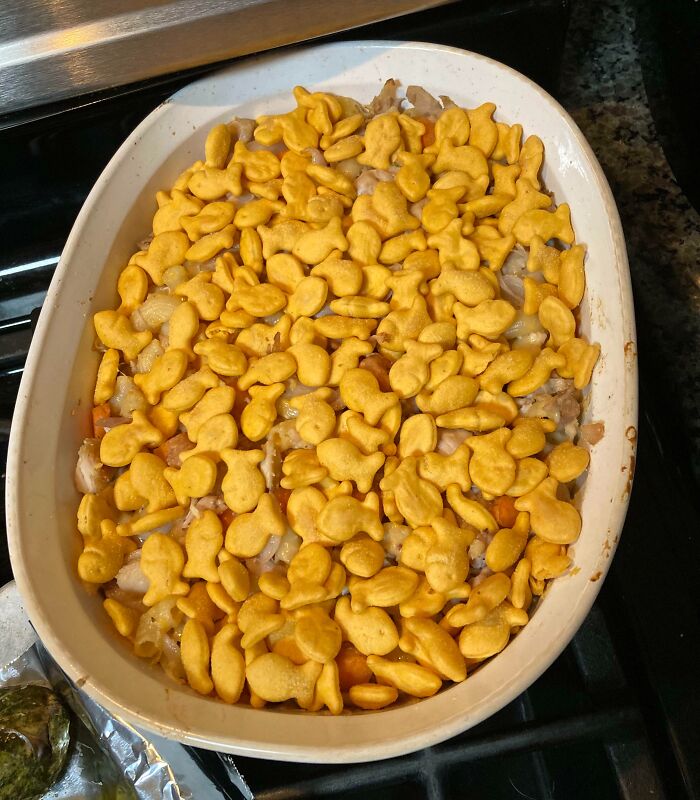 Casserole topped with uncooked goldfish crackers, showing clueless partner cooking mistake.