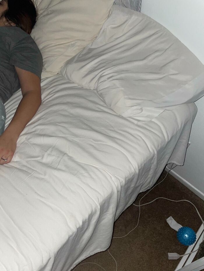 Person sleeping on one side of the bed leaving the other side completely empty showing clueless partner behavior.