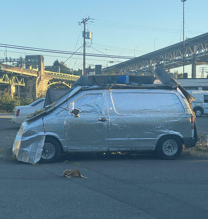 Van covered entirely in reflective material with roof modifications, an example of outrageous car mods that took things way too far.