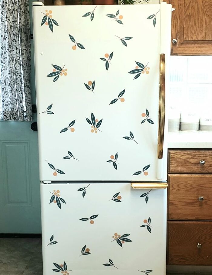 White refrigerator decorated with fun and colorful leaf and berry decals to enhance home decor and make it lively.
