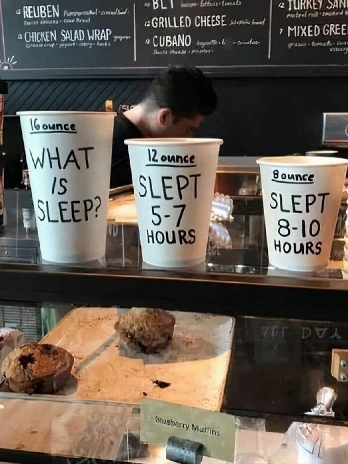 Three coffee cups with sleep-related phrases highlighting funny work memes about sleep and tiredness at work.