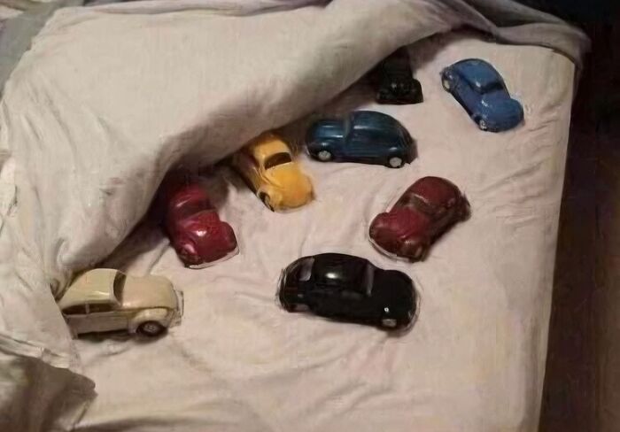 Collection of blessed images showing toy cars tucked into bed under a blanket, creating a cute and heartwarming scene.