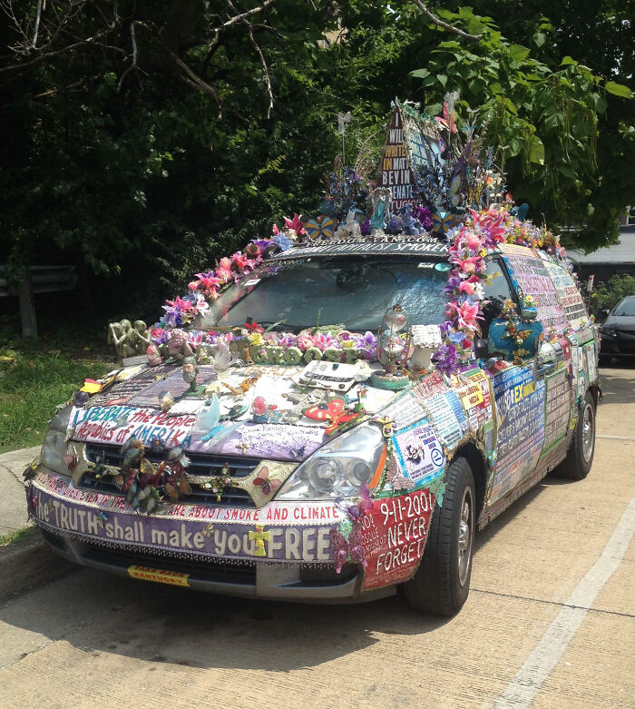 Car covered in colorful decorations and text, a unique example of outrageous car mods that took things way too far.
