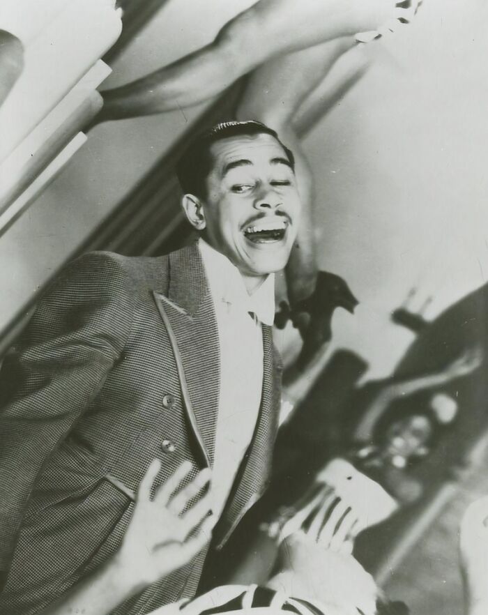 Vintage postcards from the 1930s showing a joyful man in a suit dancing with performers' legs in the background.