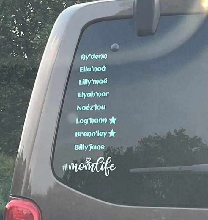 List of unique baby names displayed on a car window decal with hashtag momlife, reflecting unusual baby names judged by others.