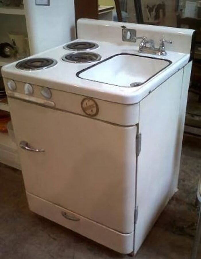 Vintage kitchen appliance combining stovetop burners and sink in a compact, retro design from past decades.