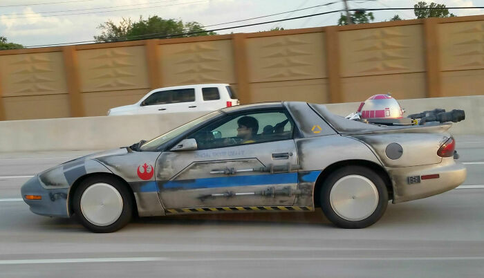 Modified car inspired by Star Wars with custom paint and added sci-fi elements, an example of outrageous car mods.