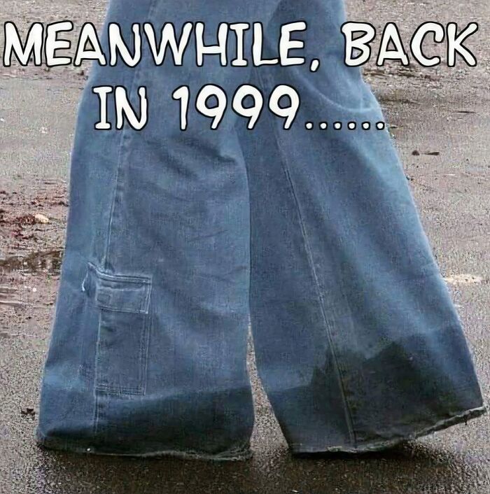 Baggy blue jeans soaked at the bottom standing on wet pavement, capturing the nostalgic magic of growing up in the ’90s.