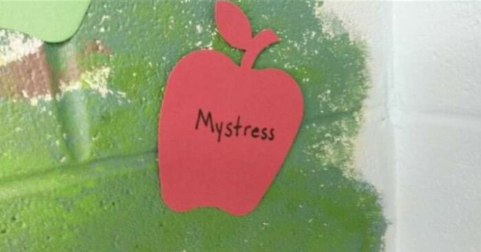 Red paper apple cutout with the name Mystress written on it, part of unusual Wednesdaigh Adams baby names display.