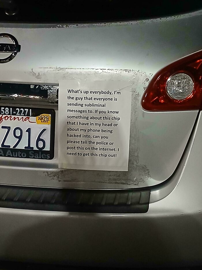 Note attached to a car saying the owner believes they have a chip sending subliminal messages, shared as a mildly interesting sight.