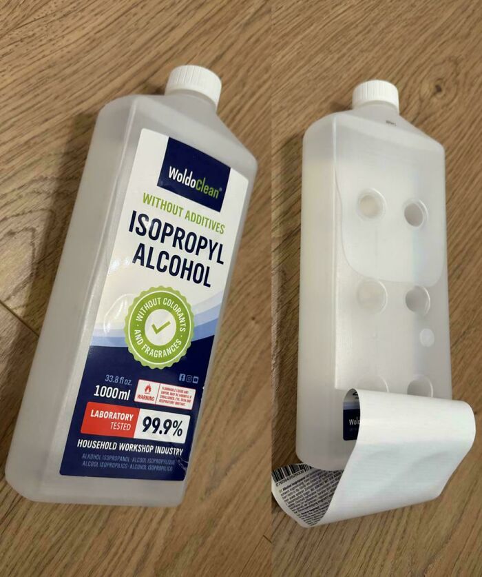 Partially peeled label on isopropyl alcohol bottle revealing suction cup-like indentations, a mildly interesting detail.