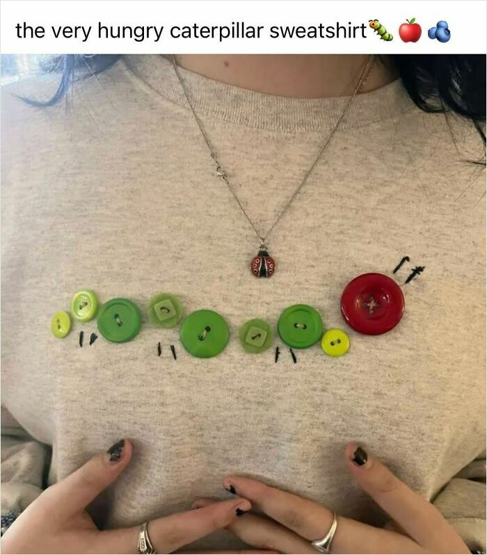 Sweatshirt with a caterpillar design made of mismatched buttons and thread, showcasing funny horrible crafts by netizens.