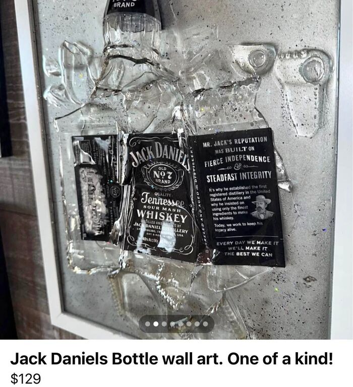 Broken Jack Daniels bottle wall art displayed as a unique craft, showcasing flawed and shamed homemade artwork by netizens.