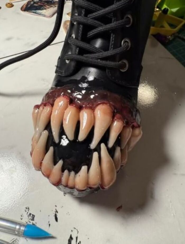 Black boot with grotesque fake teeth attached, showcasing a horrible craft that netizens shamed online.
