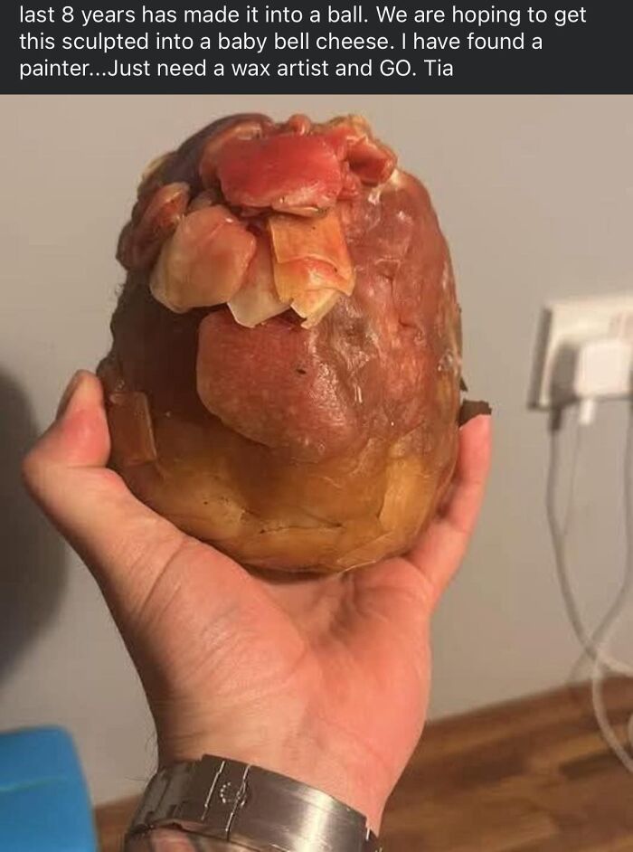 A hand holding a poorly crafted, misshapen sculpture resembling a ball, featured in horrible crafts shaming posts.