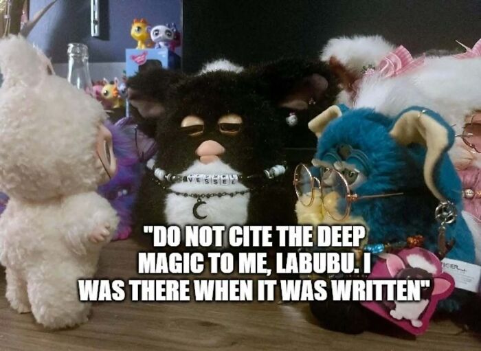 Furby dolls posed in a meme with text referencing Labubu doll and deep magic in a humorous setting.