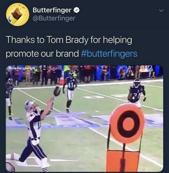 Funny official social media post with Tom Brady dropping a football symbolizing Butterfinger brand promotion on the field.
