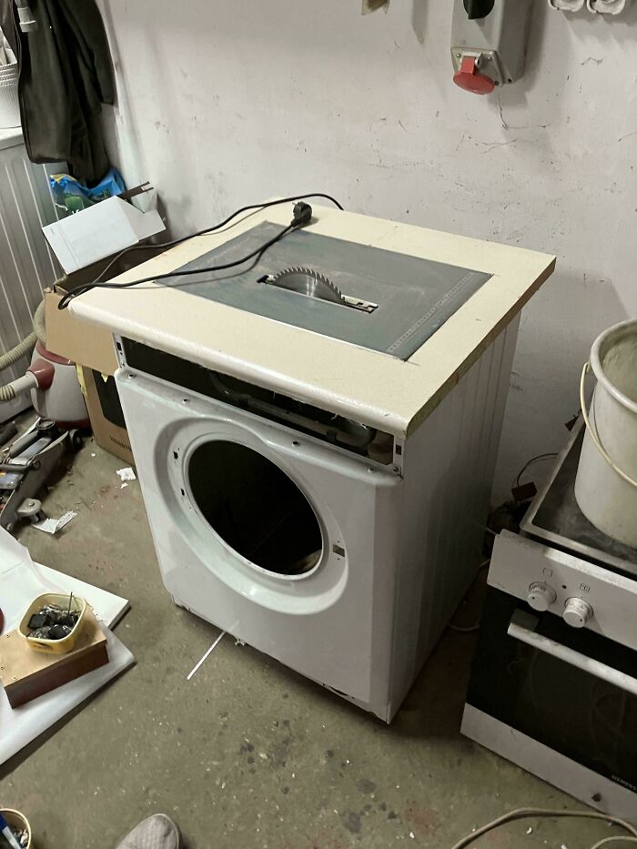 Washing machine creatively repurposed into a functional table saw showcasing redneck engineering and inventive MacGyvering skills.