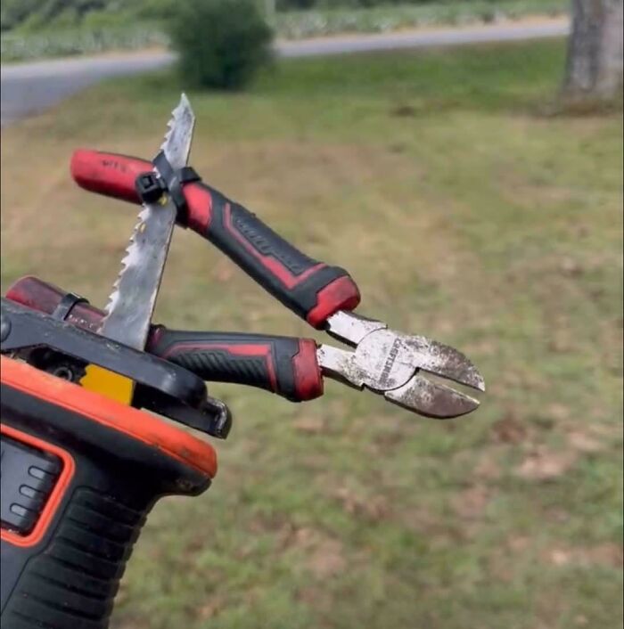 Portable tool setup showing creative redneck engineering with pliers and saw blades attached for multitasking use outdoors.
