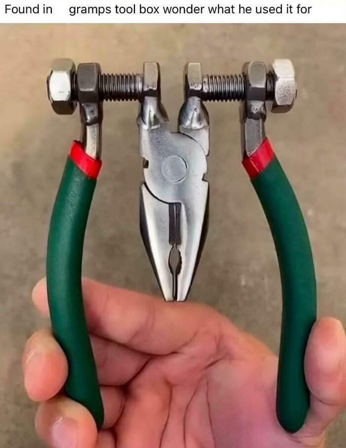 Hand holding pliers modified with bolts and nuts showcasing redneck engineering creative MacGyvering.