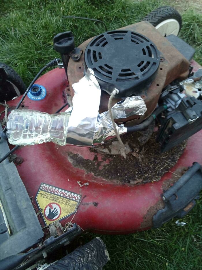 Lawn mower engine modified with a plastic bottle and foil as part of redneck engineering creative MacGyvering.