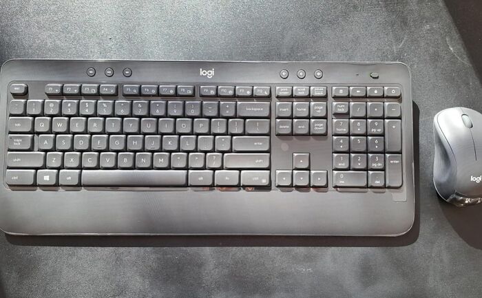 Logitech wireless keyboard and mouse set on a dark desk for back-to-school deals and syllabus preparation.