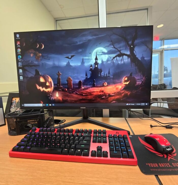 Computer setup with Halloween-themed wallpaper, keyboard, and mouse illustrating back-to-school deals for Prime Day.