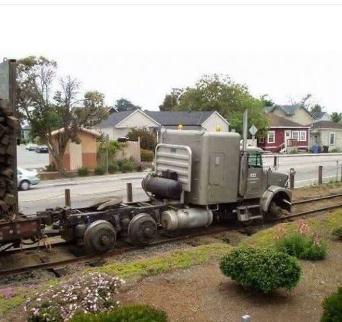 Large truck modified to run on railroad tracks showcasing creative redneck engineering and MacGyver-style improvisation.