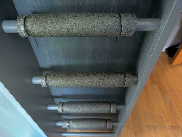 DIY redneck engineering using foam pipe insulation as rollers in a creative homemade storage or drying rack.