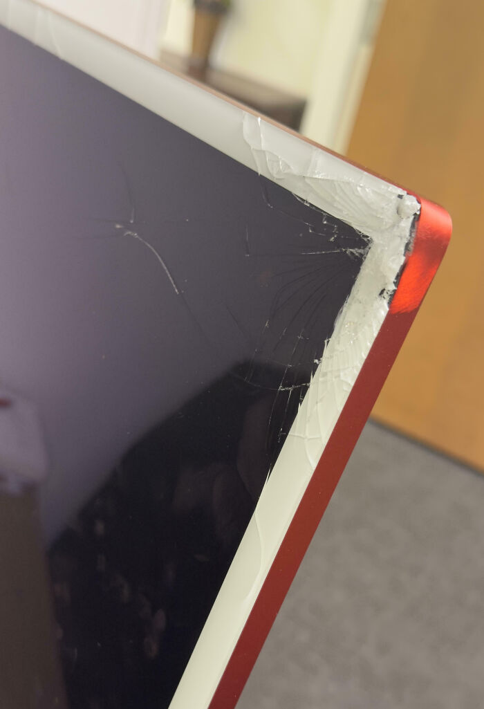 Closeup of a c*****d computer screen corner showing an epic work fail in an office environment.