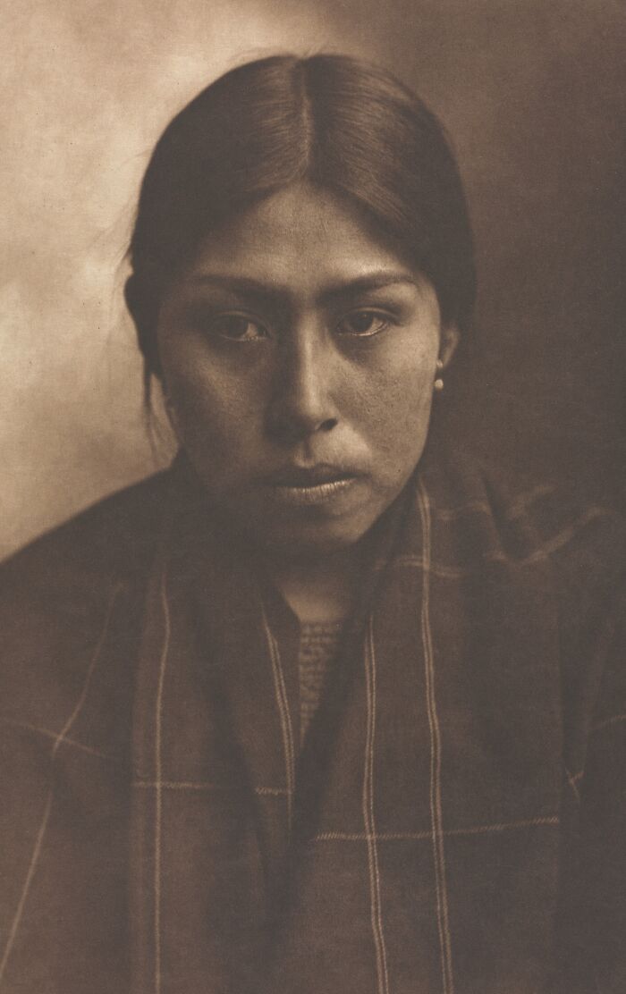 Native American woman in a sepia-toned Edward S. Curtis photo preserving Native American history and culture.