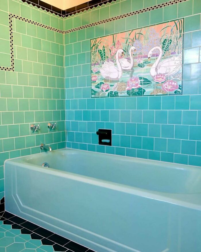 Bathroom with turquoise tile revamp featuring a swan mural above a light blue bathtub in a stylish living space makeover.