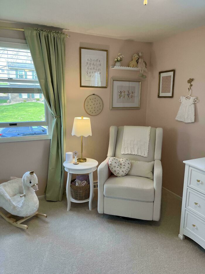 Cozy living space revamped with soft green curtains, white armchair, rocking swan toy, and delicate wall art in a nursery corner.