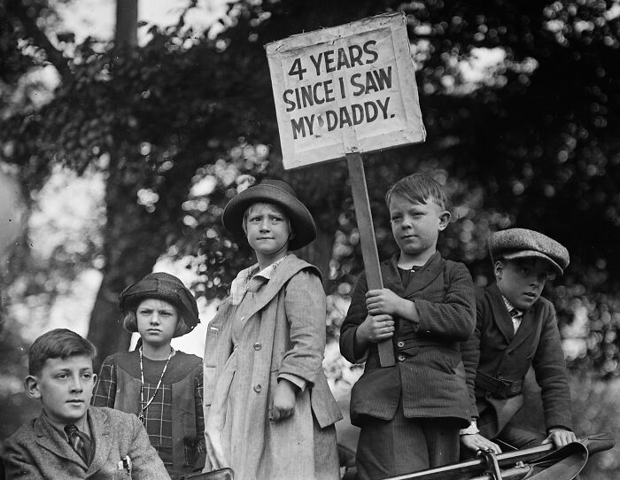 Children in vintage clothing hold a sign in Washington, D.C., during the 1920s in this historical black and white photo.