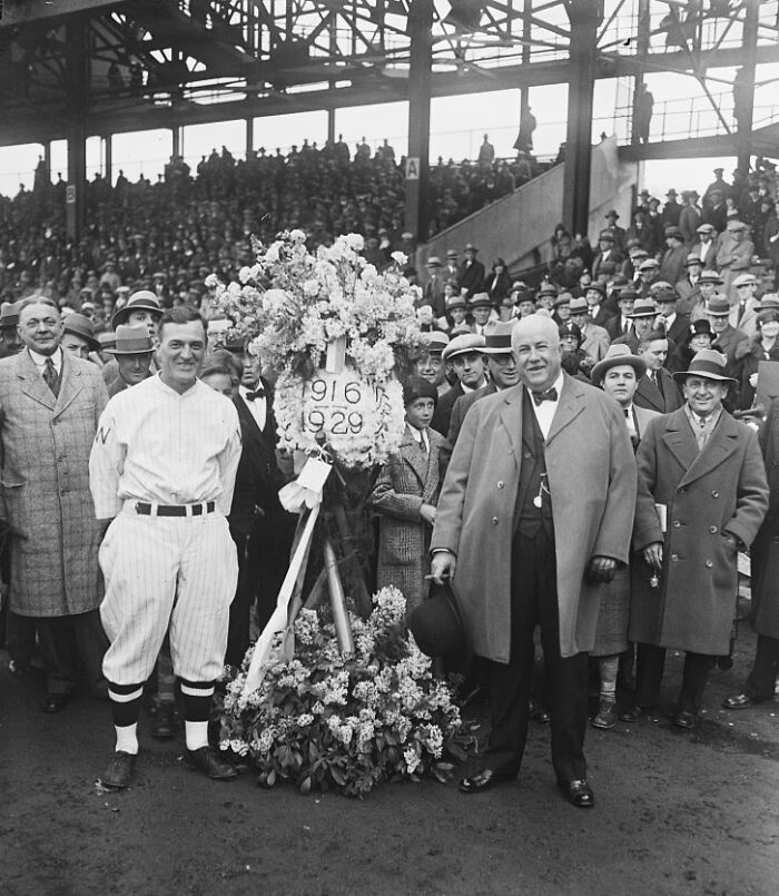 Vintage black and white photo of a crowd at a baseball event in Washington, D.C., circa 1920s with floral wreath.