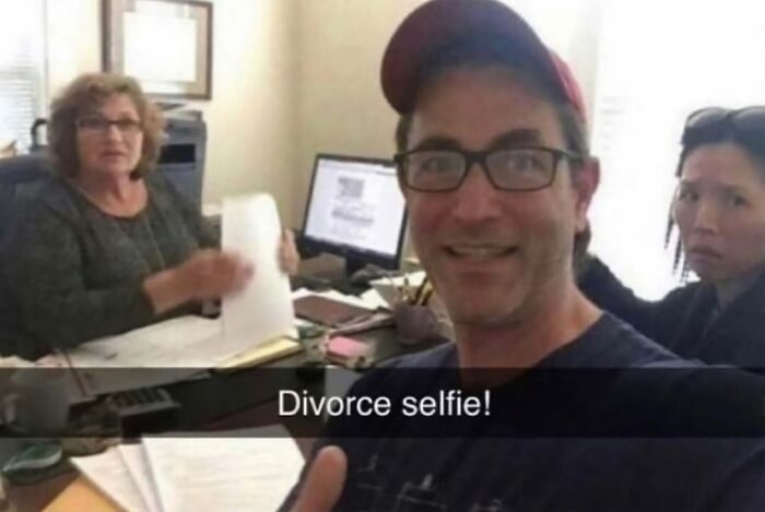 Man taking a selfie with two women in an office, captioned divorce selfie, a strange and confusing photo from viral pics.