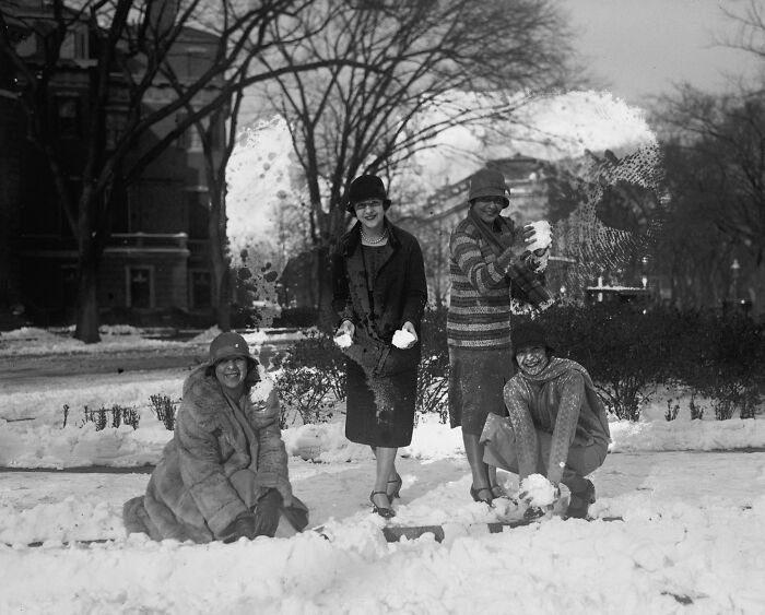 Women having a snowball fight outdoors in Washington DC in the 1920s, a vintage US historical photo.