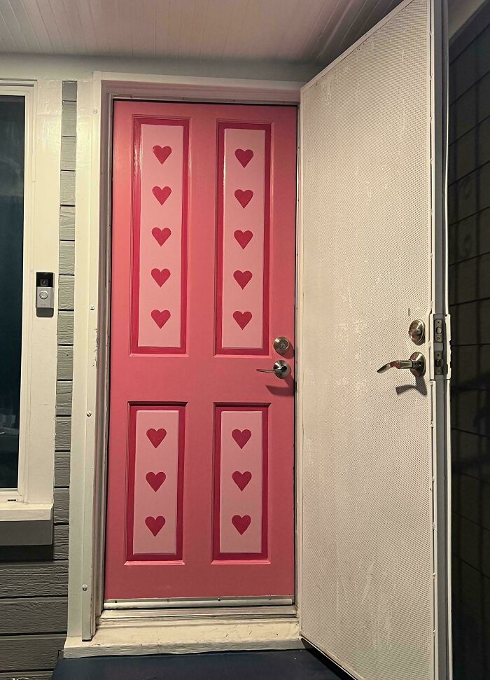Front door revamped with pink paint and heart patterns in a creative living space makeover shared online