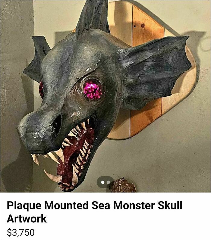 Plaque mounted sea monster skull craft with exaggerated features and pink eyes, an example of horrible crafts shamed online.