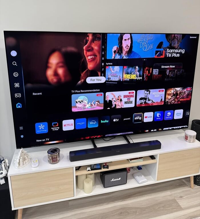 Samsung smart TV displaying streaming apps on a modern stand, highlighting deals on brands you know this Prime Day.