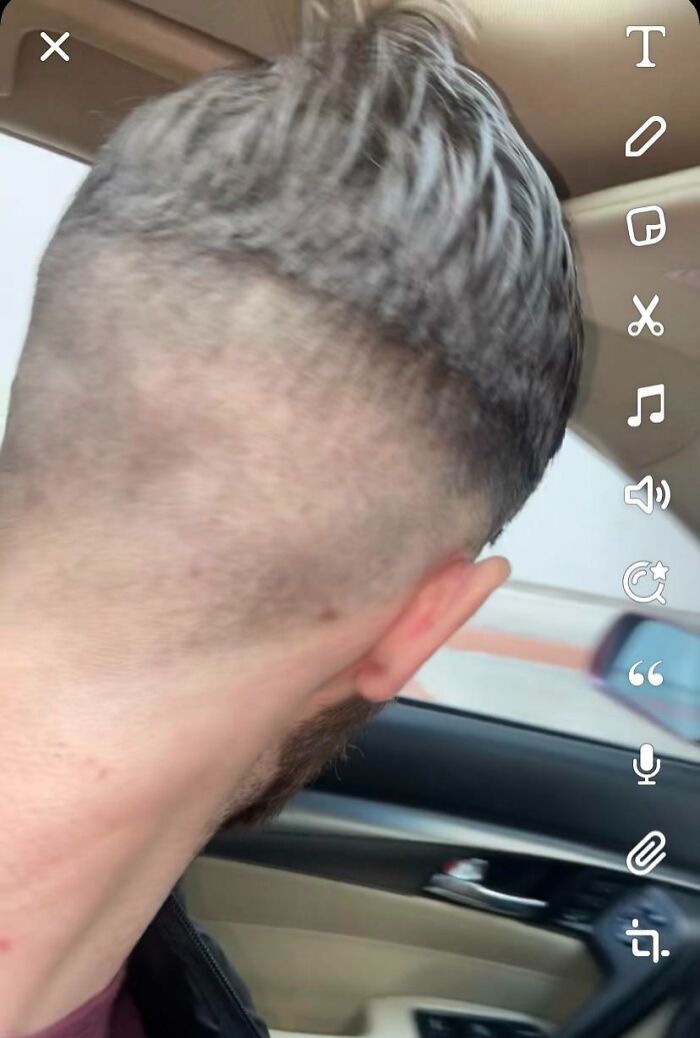 Man showing a poorly done haircut with uneven fading and patchy scalp from a salon glow-up fail.