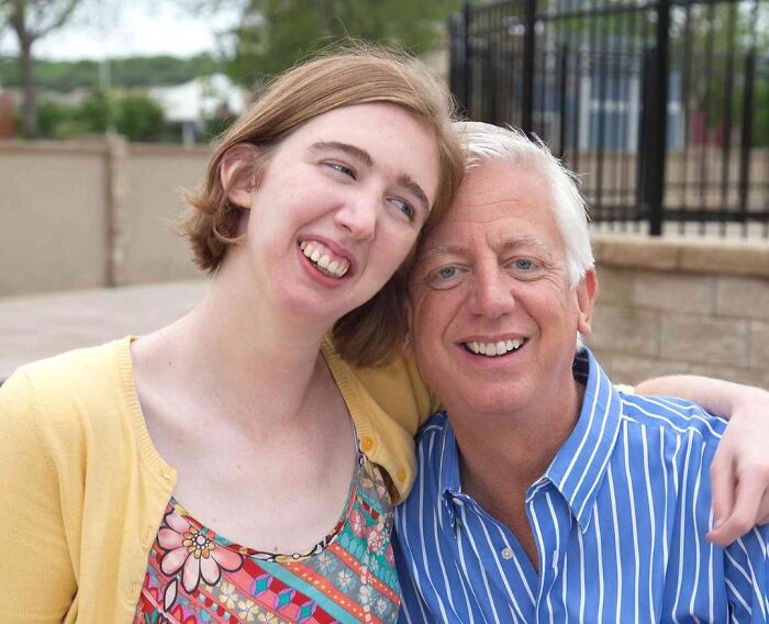 A happy father and daughter embracing outdoors, showcasing a wholesome moment in the wonderful world of family bonds.