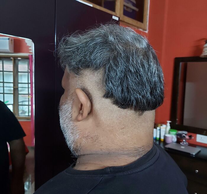 Man with uneven and patchy haircut in salon, illustrating a glow-up attempt that led to a breakdown experience.