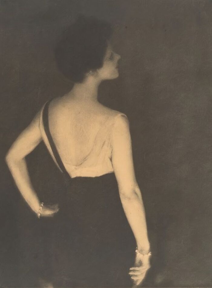 Vintage photo of a woman from the 1900s wearing a dress, showcasing the beauty of women in old photos.