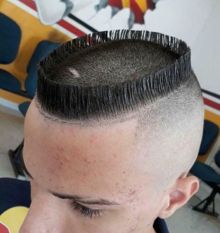 Man with unusual haircut at salon, showcasing a unique glow-up that led to a surprising breakdown reaction