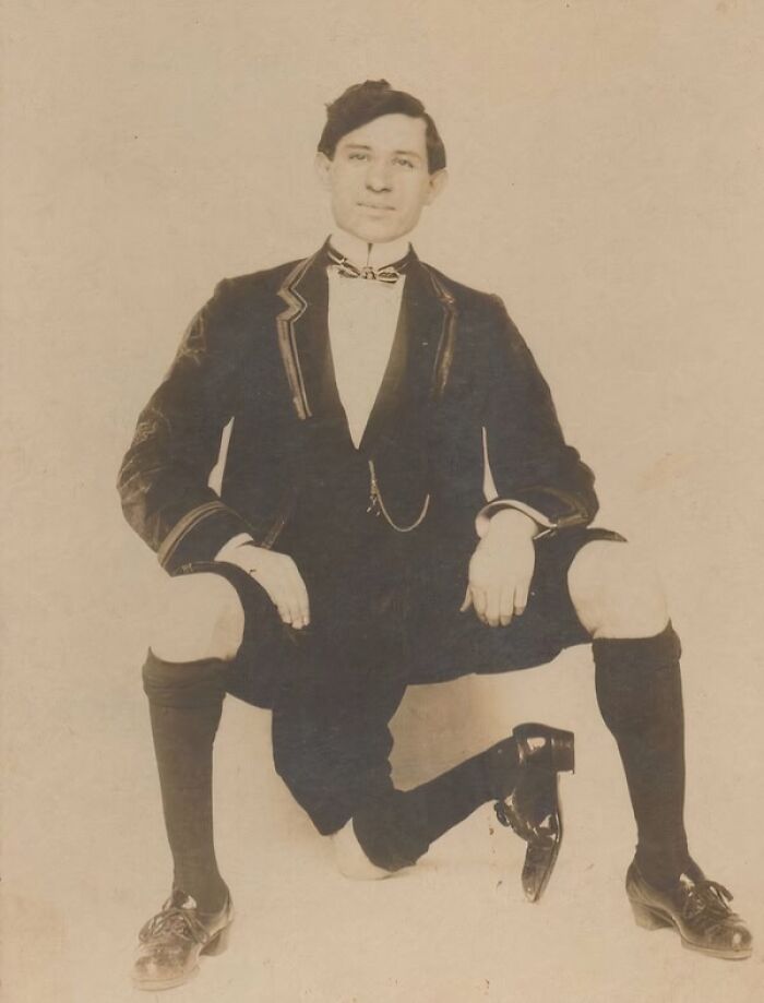 Vintage unique old photo of a man in formal attire posing with one knee on the ground, showing historic fashion details.